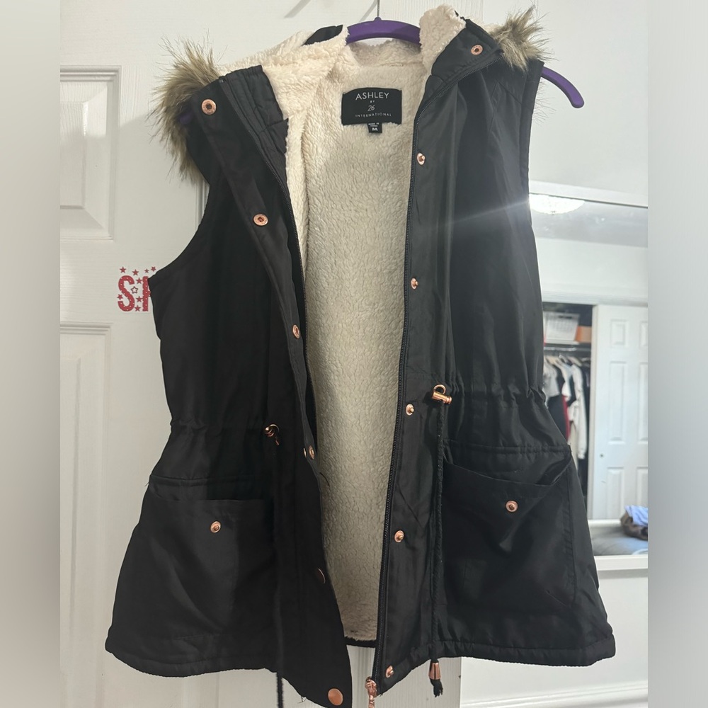 Black Vest with hood. Cinched waist feature.